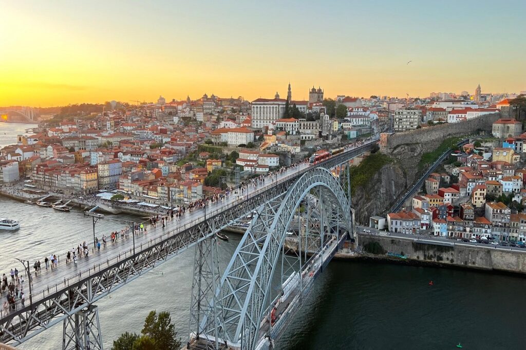 The iconic Dom Luis I bridge on the Douro River at sunset for Porto cannabis Travel Guide CannaTrailz