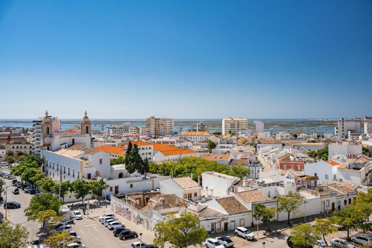 cityscape view of Faro city center with ocean in background for cannabis travel Guide cannatrailz