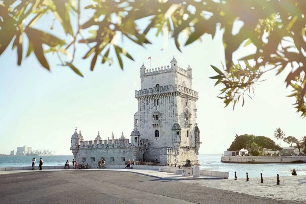 The iconic Belem Tower on the bank of the Tagus River on a sunny day for Lisbon cannabis travel guide CannaTrailz