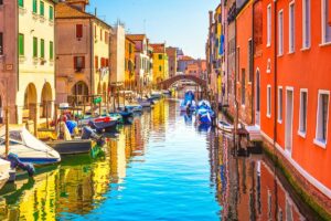 Colorful buildings along serene canal for Cannabis in Chioggia Travel Guide.