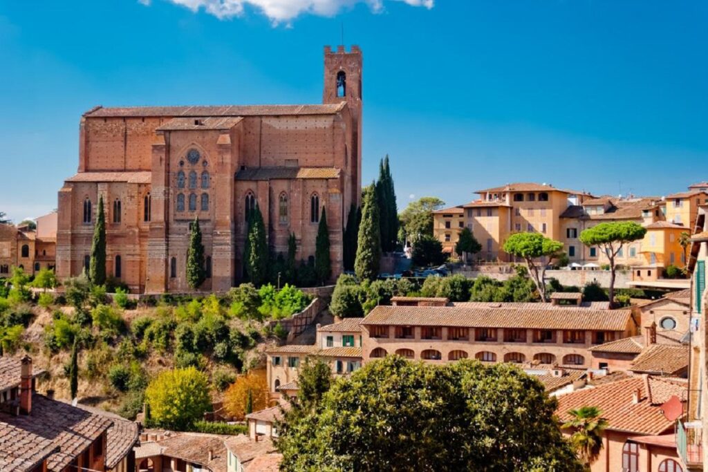 The San Domenico Basilica on a sunny day for Cannabis in Siena Travel Guide.