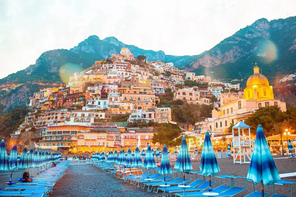 View of cliffside houses from the beach for Cannabis in Positano Travel Guide.