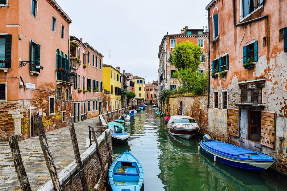 Gondolas anchored along the canals with historic buildings in Venice, Italy.