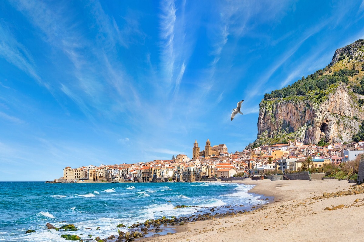 The lungomare and beach on a sunny day for Cannabis in Cefalù Travel Guide.