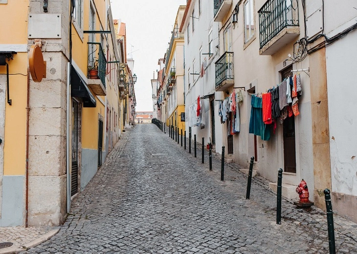 Bairro Alto changes the visibility of cannabis in Lisbon with narrower streets and dense nightlife.