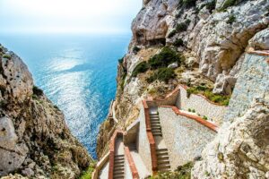 Scenic stairway by the coast for Cannabis in Alghero Travel Guide.