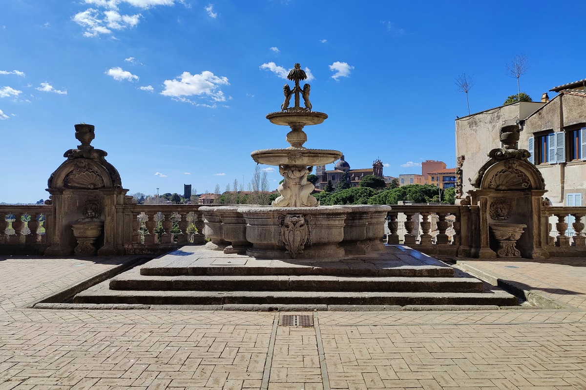 The Palazzo dei Priori with blue clouds for Cannabis in Viterbo Travel Guide.