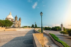 A sunlit Our Lady of Sameiro Sanctuary under clear blue sky in Braga, Portugal.