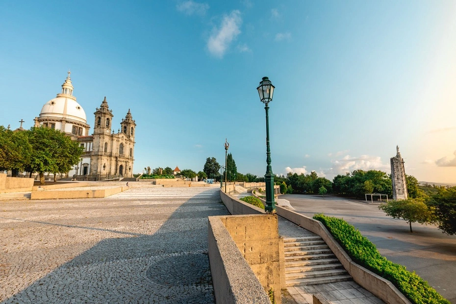 A sunlit Our Lady of Sameiro Sanctuary under clear blue sky in Braga, Portugal.