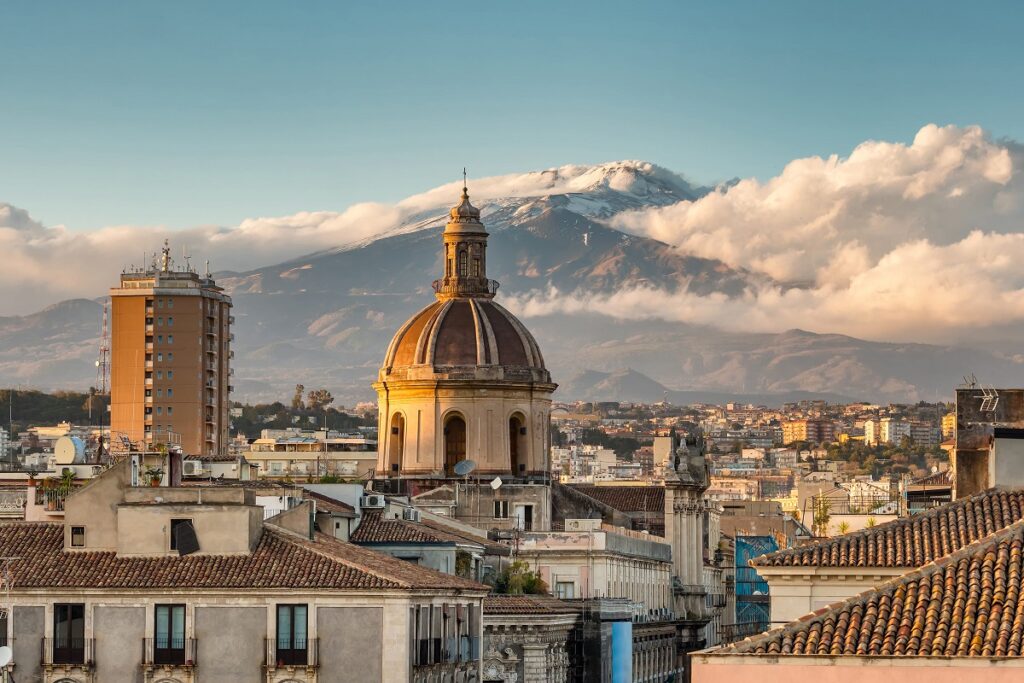 Cross city view of Church dome & Mt. Etna for Cannabis in Catania Tarvel Guide.