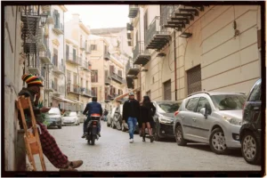 Urban street view with pedestrians and vehicles in Palermo, Sicily, Italy.