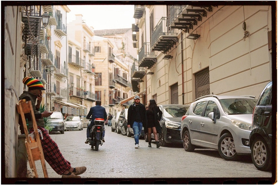 Urban street view with pedestrians and vehicles in Palermo, Sicily, Italy.