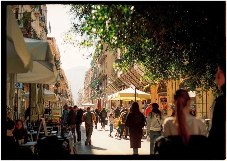 A bustling street showcasing local life which influences the culture of cannabis in Palermo.