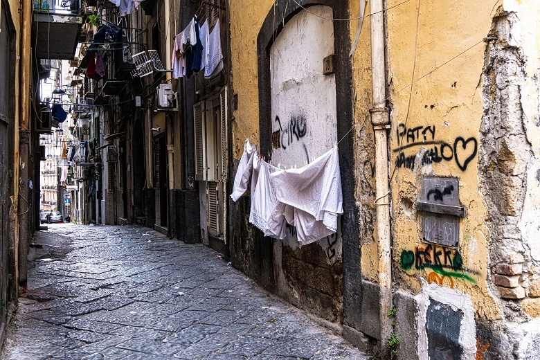 A narrow alley with graffiti covered walls in the Spanish quarter often considered home of cannabis in Naples.