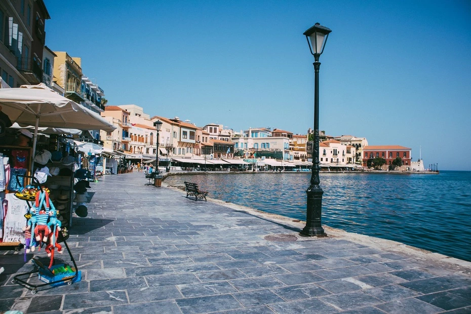 Waterfront promenade and historic buildings along the old Venetian harbour in Chania, Crete Island, Greece.