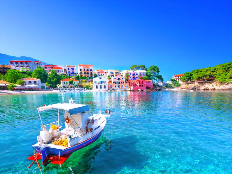 Turquoise water and colorful boats for cannabis in Ionian Islands.