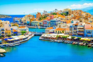 Colorful houses around Lake Voulismen in Agios Nikolaos, Greece.