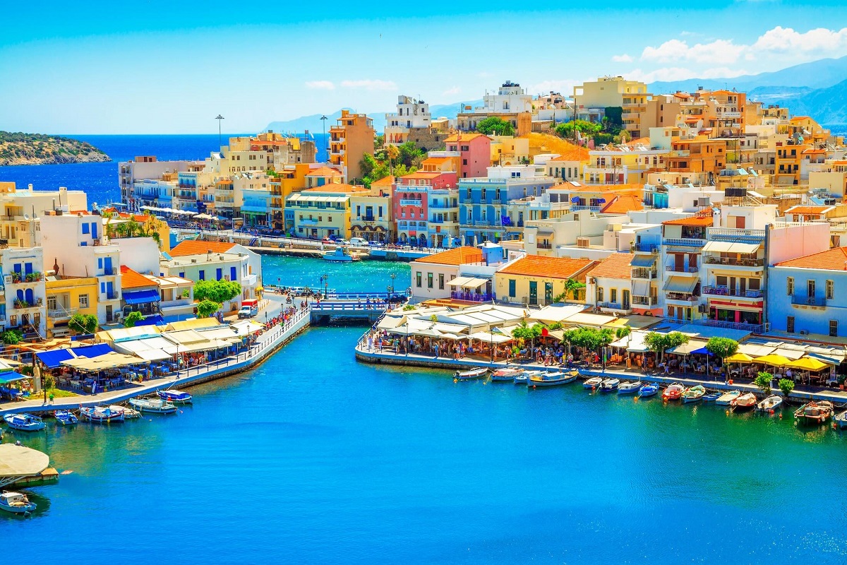 Colorful houses around Lake Voulismen in Agios Nikolaos, Greece.