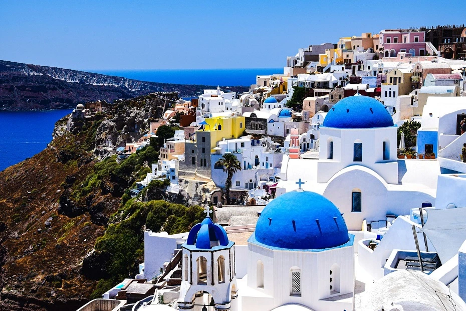 The famous blue-domed churches and whitewashed buildings on Santorini Island, Greece.