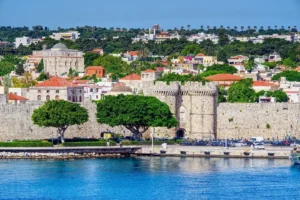 View of historic Rhodes fortress and waterfront on a sunny day on Rhodes Island in Greece.